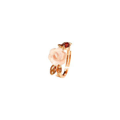 Three-dimensional rose quartz rose and garnet ring